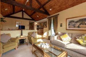 a living room with two couches and a table at Underscar - Luxury 1 Bed Apartment in Applethwaite