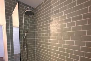 a bathroom with a shower with gray tiles at Pets - Garden - Parking - Sleeps up to 4 - Hiking in Banchory +3 photos