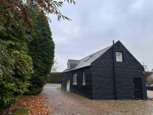 a black brick house with a driveway at Pets - Garden - Parking - Sleeps up to 4 - Hiking in Banchory
