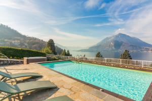 a swimming pool with a view of a mountain at Villa La Perledina in Perledo