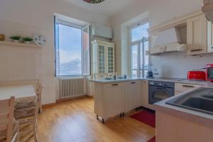 a kitchen with a sink and a counter top at Villa La Perledina in Perledo