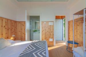 a bedroom with a large bed and wooden walls at Villa La Perledina in Perledo +80 photos