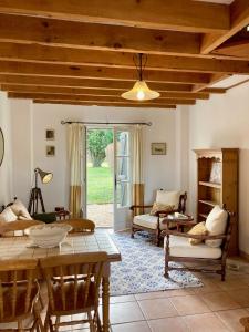 a large living room with a table and chairs at Reves au Soleil in Thiviers