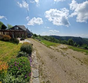 a dirt road in front of a house at Chalet "Quelle Vue" in Coubisou