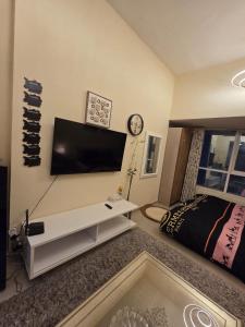 a living room with a flat screen tv on the wall at Apartment in ajman in Ajman 