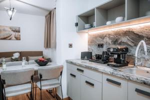 a kitchen with a sink and a counter with a coffee maker at ILIADA Boutique Rooms in Faliraki