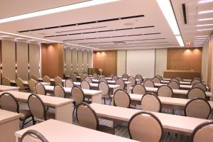 an empty lecture room with tables and chairs at Heaven Prestige Hotel in Jounieh +125 photos