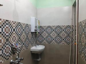 a bathroom with a toilet and a shower and a sink at Ocean Wind Homestay in Pondicherry