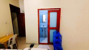 a bathroom with a toilet and a red doorway at Park View Perch Guest house with Balcony near Downtown in Kigali