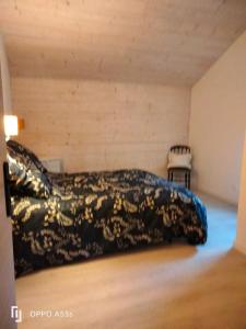 a bedroom with a bed and a chair at Bordeneuve in Le Passage