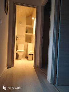 an open door to a bathroom with a toilet at Bordeneuve in Le Passage +5 photos
