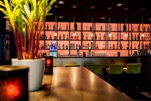 a bar with a large wall of wine bottles at NH Bussum Jan Tabak in Bussum