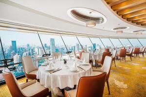 a restaurant with tables and chairs and a view of the city at Radisson Blu Hotel Shanghai New World in Shanghai