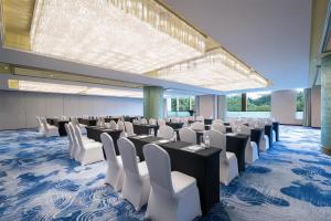 a conference room with tables and white chairs at Radisson Blu Hotel Shanghai New World in Shanghai +115 photos