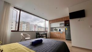 a bedroom with a bed and a large window at Nuevo y moderno departamento Quito Norte in Quito