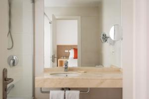 a bathroom with a sink and a mirror at BYPILLOW Tiento in Cádiz +49 photos