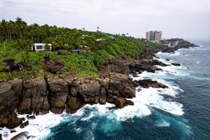 an aerial view of a rocky coastline with the ocean at Rumassala Villas in Unawatuna