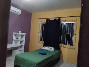a small room with a bed and a window at Chalé Santarém, located in Mosqueiro! in Belém +4 photos