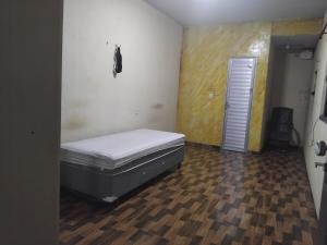 a room with a bed in the corner of a room at Chalé Santarém, located in Mosqueiro! in Belém