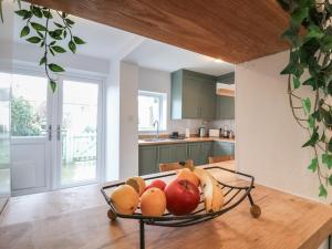 a bowl of fruit on a table in a kitchen at Meregate Cottage in Margate