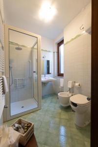a bathroom with a shower and a toilet and a sink at Locanda Severino in Caggiano