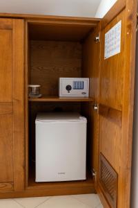 a microwave and a refrigerator in a cabinet at Locanda Severino in Caggiano +4 photos