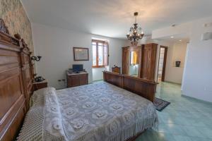 a bedroom with a bed and a chandelier at Locanda Severino in Caggiano