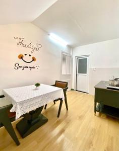 a room with a table and a sign that says thanks see your spirit at New Sala Homestay in Hue