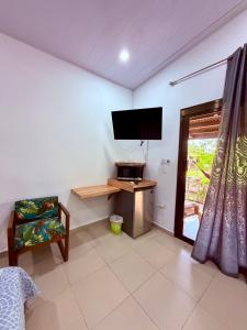 a living room with a flat screen tv on the wall at Cabañas Quebrada del Pueblo in Dolega