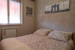 a bedroom with a bed with two pillows and a window at Albergo Ristorante Brera in Inveruno