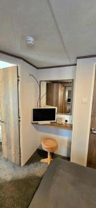 a room with a desk and a stool in a room at CJ's Happy Place in Heysham