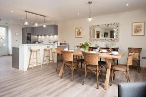 a kitchen and dining room with a table and chairs at Old Granary House in Chesters