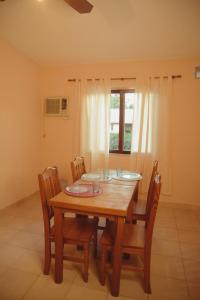 a dining room with a wooden table and chairs at Departamento espiral in Embalse +4 photos