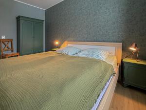 a bedroom with a large bed with two night stands at Schöngrün in Sankt Andreasberg