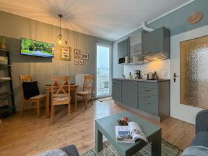 a living room with a kitchen and a table at Schöngrün in Sankt Andreasberg