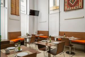 a restaurant with tables and chairs and a television at BYPILLOW Tiento in Cádiz