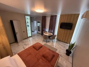 a bedroom with a bed and a table in a room at Urban Nest in Truskavets