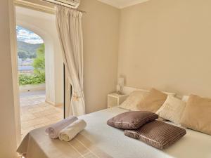 a bedroom with a bed with two pillows on it at Poltu Quatu House in Porto Cervo +24 photos