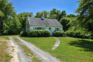 a small white house with a dirt road at Huge Deck Outdoor Shower Dog Friendly in Brewster