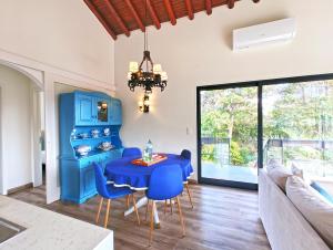 a dining room with a blue table and blue chairs at O Nosso Refúgio in Água de Pau +32 photos