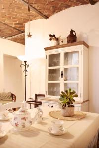 a dining room table with a china cabinet and a plant at Il Casale Naturart in Quarrata +95 photos