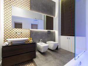 a bathroom with a sink and a toilet at Varò Apartment in Taormina +14 photos