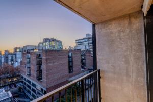 a balcony with a view of a city at Live Suites in Montevideo