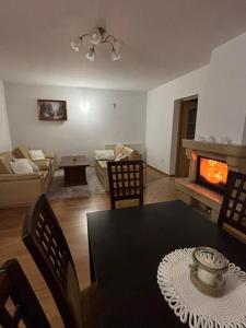a living room with a table and a fireplace at Domek nad Sołą in Cisiec