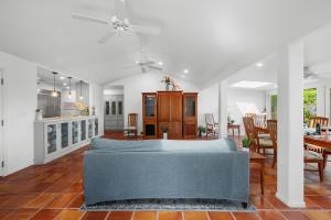 a living room with a couch and a dining room at Alaeloa 35 in Kapalua