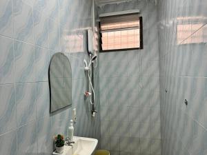 a bathroom with a shower and a sink at The Petrance Apartment in Cape Coast