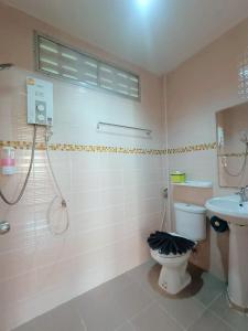 a bathroom with a toilet and a sink at Rachawadee House Phang Nga in Phangnga