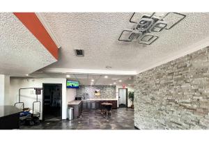 an office lobby with a stone wall at Studio 6 Mobile AL in Mobile