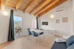 a living room with a table and chairs and a couch at Il Parco Apartment- Nature & Relax-Road To 5Terre in Beverino