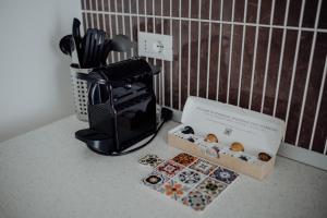 a box of donuts sitting next to a coffee maker at Palazzo Pezzolla Apartments in Monopoli